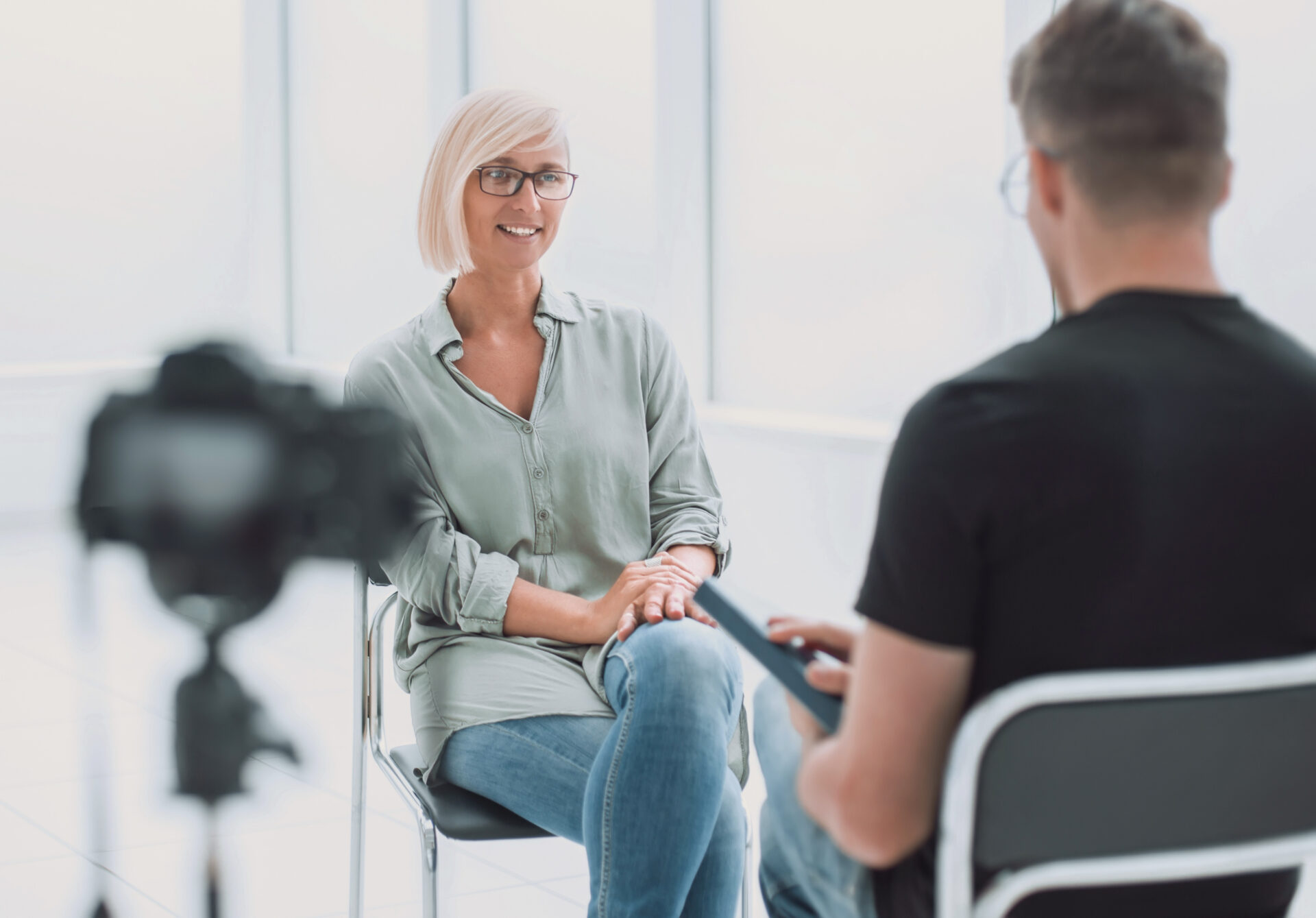 background image of a man and a woman sitting in the Studio during the interview. photo with copy space