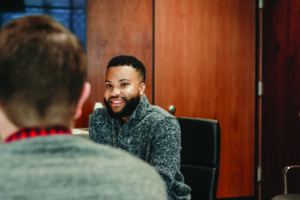 M&R team member in a conference room conducting a discovery meeting with a client.