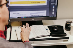 M&R team member at his desk working on a client's video and photography strategy.