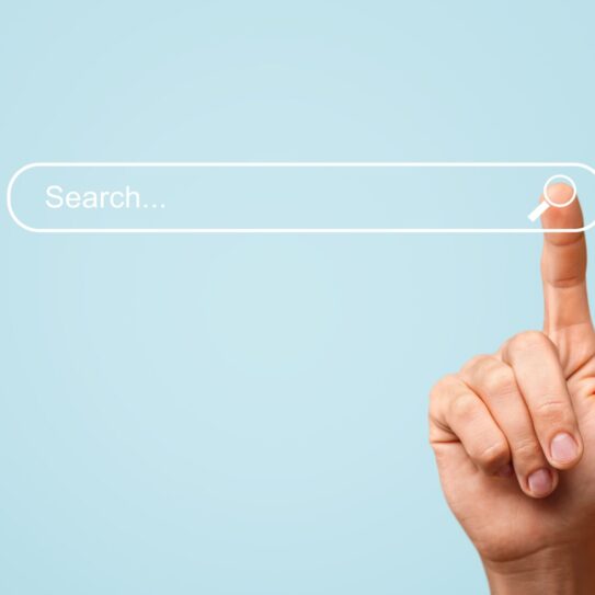 A search bar with a human finger tapping on the magnifying glass icon on the right side of the bar.