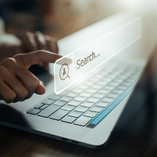 Hand using laptop and press screen to search Browsing on the Internet online.